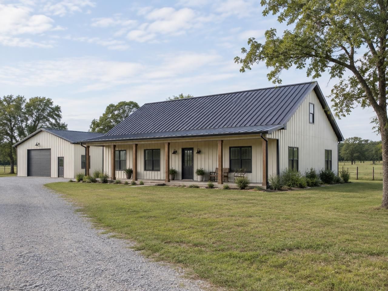 Illustrative building concept — AI-generated, not a completed Outlaw Building Co. project AI-generated illustration: White metal barndominium with a timber-post covered porch, windows and an adjoining shop on a rural property. Not a completed Outlaw Building Co. project.