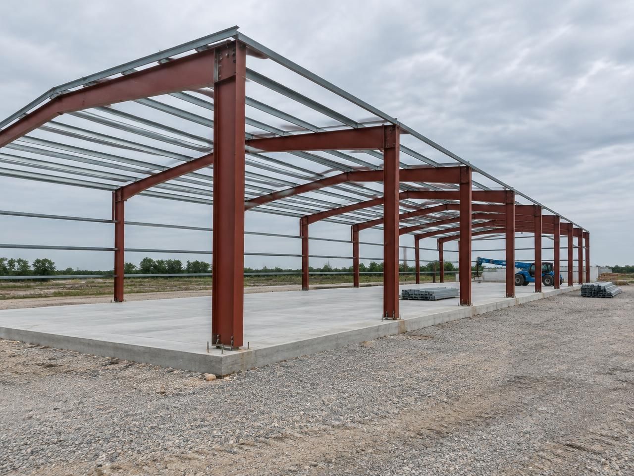Illustrative building concept — AI-generated, not a completed Outlaw Building Co. project AI-generated illustration: Large red oxide steel portal frames with roof purlins at an industrial construction site. Not a completed Outlaw Building Co. project.